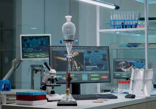 Microbiology laboratory filled with chemical research equipment tools. Test tube for experiment used in pharmaceutical development industry. Microscope, vacutainers, and pipette on desk