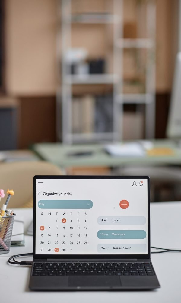 Vertical shot of online calendar page on laptop screen for schedule planning. Personal and business organizer, copy space