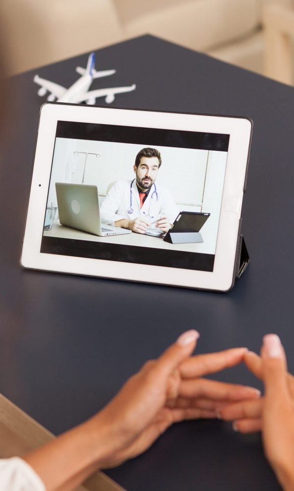 Woman talking with physician during a video call on tablet computer.
